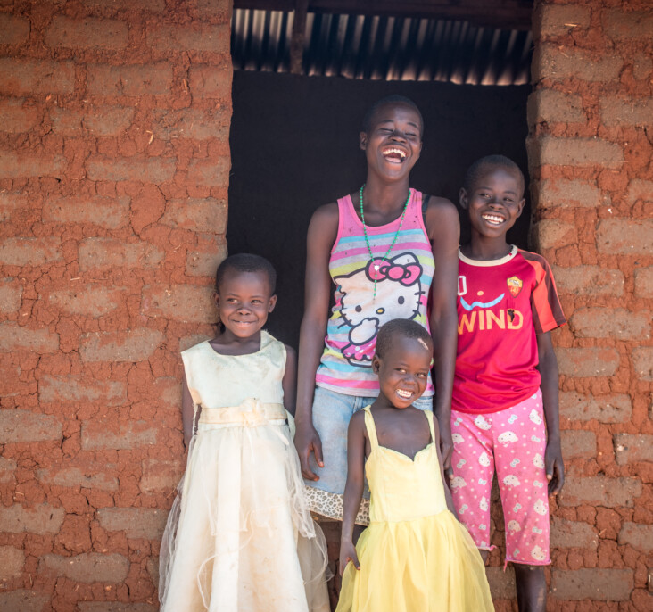 Annet and her family were living in a tent in the Bidi Bidi settlement before CRS built them a house. The tent had tears in it and leaked during rain. “I can imagine being happy in this house,” Annet says. “I see my siblings happy and feel there is still hope for them.” Photo by Philip Laubner/CRS.