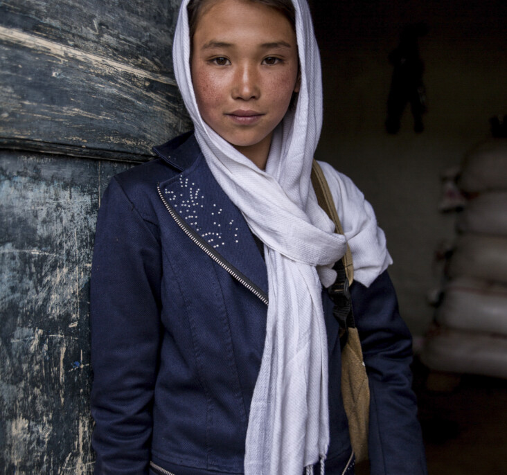 Rahna, 10, attends a CRS-funded school near her home in Ghor Province, Afghanistan. Community-based education matters in rural towns like Rahna’s, where the nearest government school is more than five miles away. It is only accessible by crossing dangerous mountains where wild dogs and wolves live, or by following the main road where children often get hit by cars. Photo by Stefanie Glinski for CRS