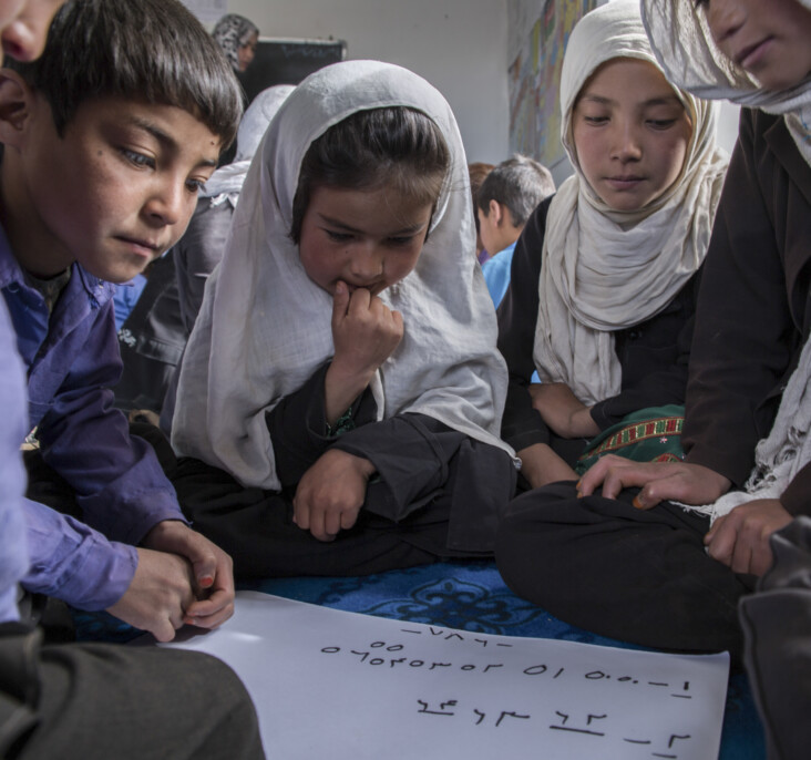 Children study at a CRS-established school in rural Afghanistan. This village is home to 45 families, many of which had never attended school before. Community-based education is essential in rural Afghanistan, as it otherwise often means that no education at all is available. Photo by Stefanie Glinski for CRS